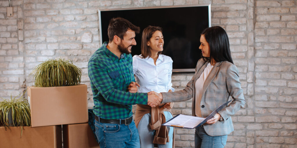 Young couple buying a new home from the sales agent