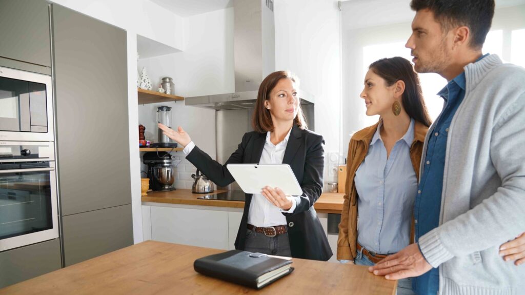 Couple with real-estate agent visiting house for sale